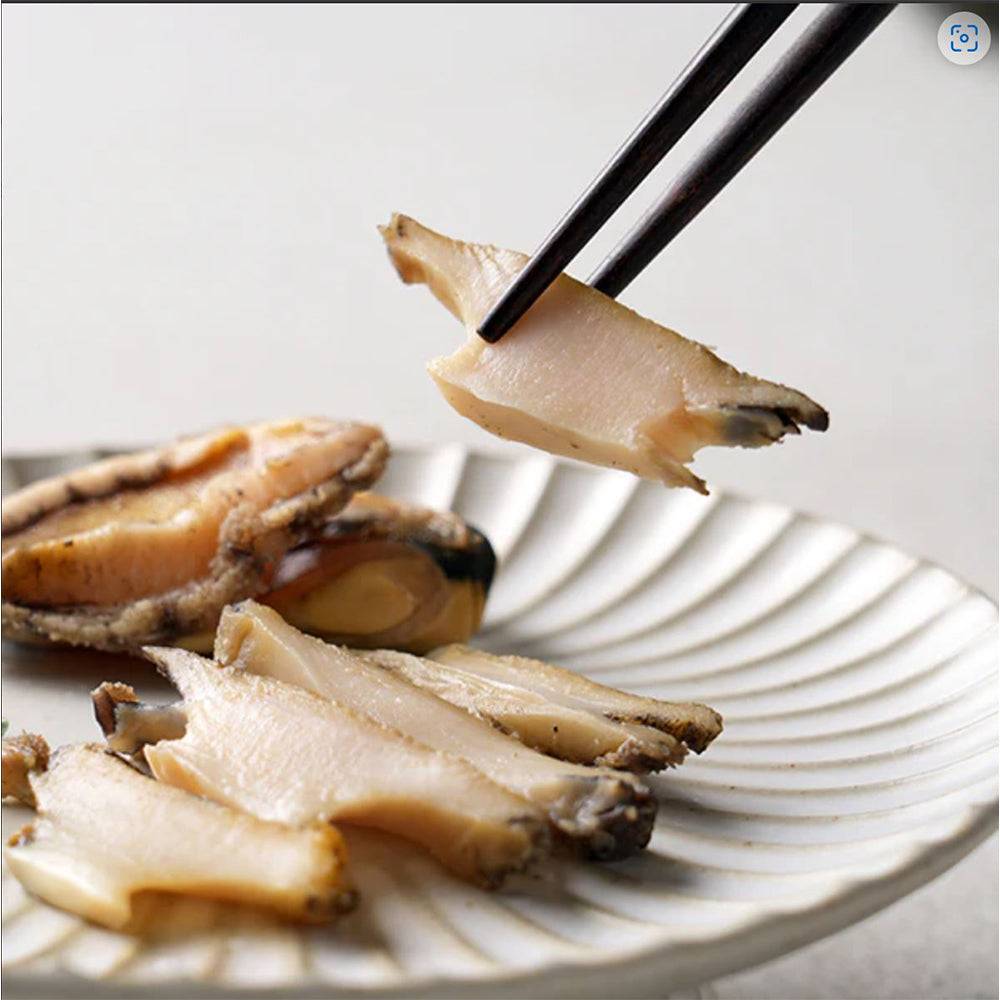 a plate of food with chopsticks sticking out of it